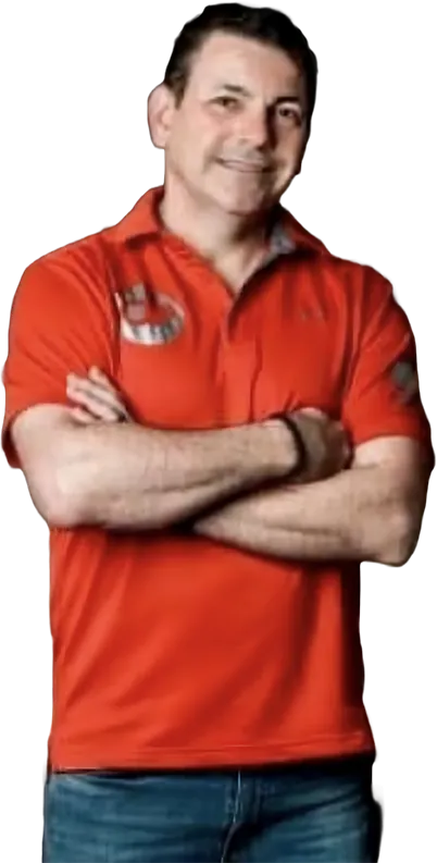 Man in red polo shirt with crossed arms, representing Owner's Pride car detailing services in Omaha, NE.